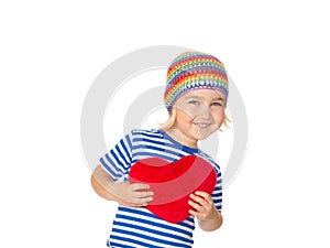 Little girl holding a red heart toy.