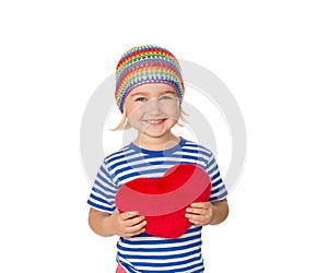 Little girl holding a red heart toy.