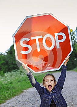 Little girl holding a red sign