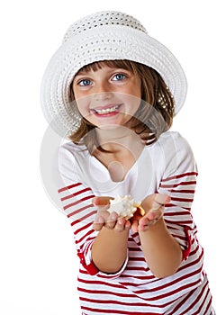 Little girl holding a shell