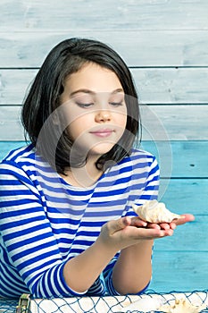 Little girl holding a shell