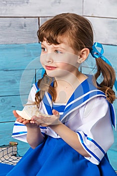 Little girl holding a shell