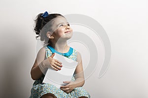 Little girl  holding a small cubical box in hands mock-up series photo