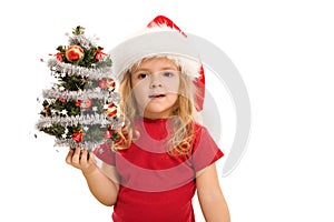Little girl holding small decorated christmas tree