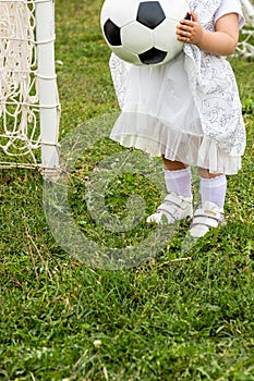 Little girl holding soccer ball