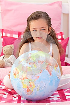Little girl holding a terrestrial globe