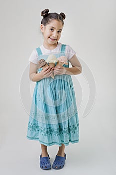 Little girl holding three ice cream cones