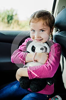 Little girl holding a toy