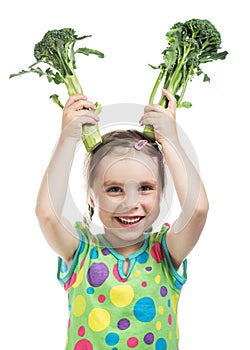 Little girl holding two broccoli
