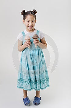 Little girl holding two ice cream cones