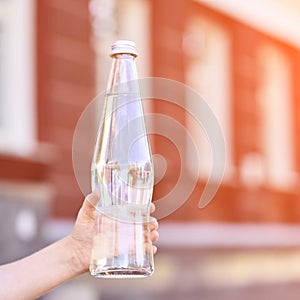 Little girl holding water bottle. Outdoor training. Thirsty. Glass drink