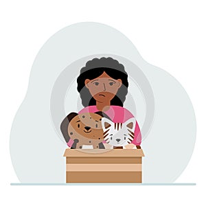 A little girl holds a cardboard box with a cat and a dog. The concept of rescue, help and care for pets.