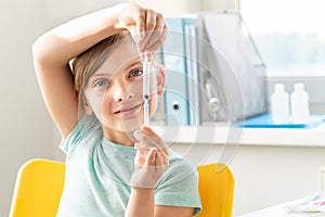 Little girl in holds in hands syringe, play with vaccine for covid-19 coronavirus,flu,dangerous infectious diseases. Kids plan