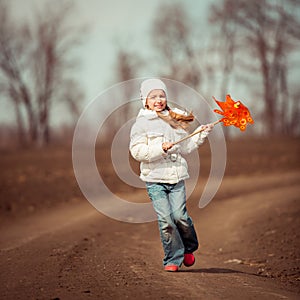Little girl holds windmill in hand