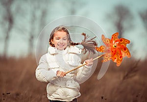 Little girl holds windmill in hand