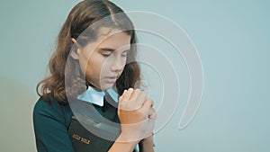 Little girl holy bible prays with bible in her hands. the catholicism sacred holy bible. children and religion