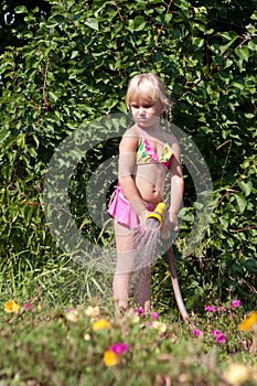 Little girl with hosepipe