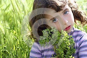 Little girl hug green plant meadow spikes