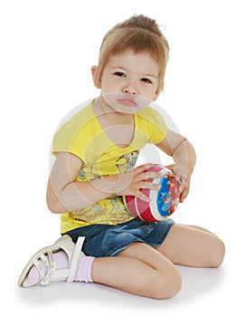 Little girl hugging the ball.