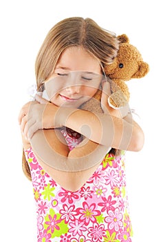 Little girl hugging bear toy
