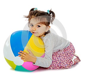Little girl hugging a big ball