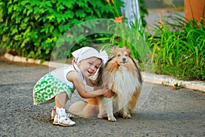 Little girl hugging a dog.