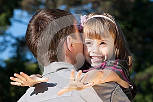 Little girl hugging embracing her father