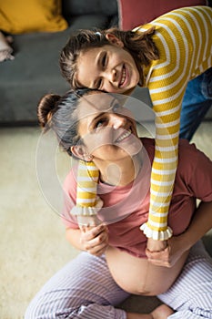 Little girl hugging her pregnant mom