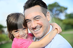 Little girl hugging her smiling father