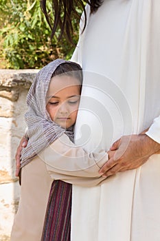 Little girl hugging Jesus photo