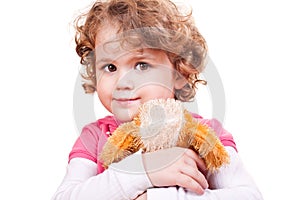 Little girl hugging toy dog