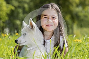 Little girl with husky puppy