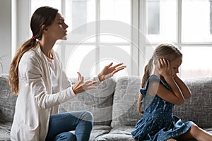 Little girl ignore young mom scolding and lecturing