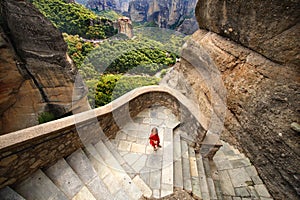 A little girl immersed in the panorama of Meteora