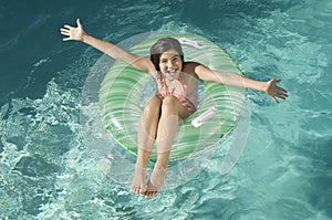 Little Girl On Inflatable Ring With Arms Outstretched