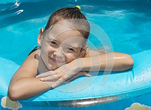 Little girl in inflatable swimming pool photo