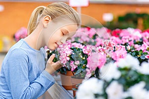 Little girl inhaling flower scent