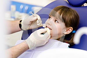 Little girl during inspection of oral cavity photo