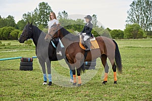 Little girl jockey and her coach ridding a horse