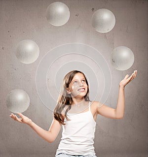 Little girl juggling with crystal sphere balls