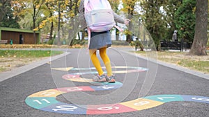 Little girl jumping in autumn park