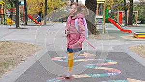 Little girl jumping in autumn park