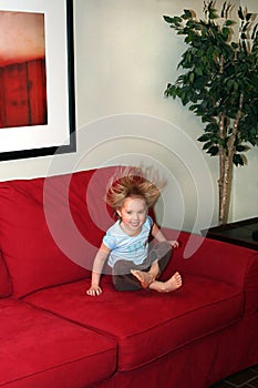 Little Girl Jumping on Couch