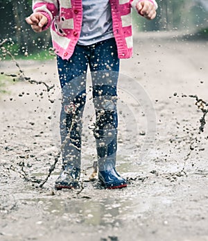 Little girl jumping in a paddle