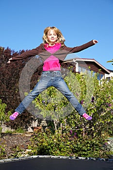 Little girl jumping on trampoline