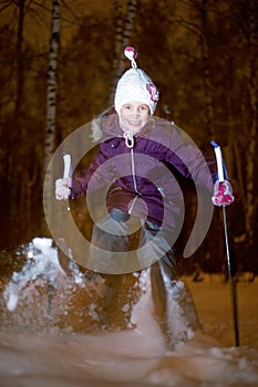 Little girl jumps on ski at winter park