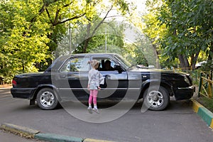 Little girl jumps to window to see sitting in the car Grandpa