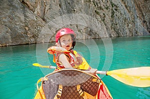 Little girl kayaking on beautiful river, having fun and enjoying sports outdoors. Water sport and camping fun. Mont-rebei gorge