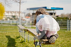 Little girl keeping balance in playground doing fun activities - Kid playing outside in spring