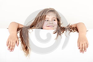 Little girl kid with long hair holds empty banner.